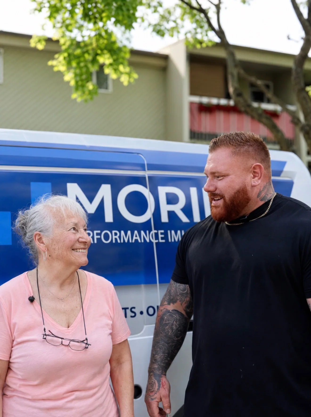 A Gestion Morin representative talking with a tenant in front of the company van.